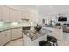 An open-concept kitchen with stainless steel appliances, white cabinetry, and a center island at 11137 Woodland Waters Blvd, Weeki Wachee, FL 34613