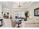 Inviting living room featuring high ceilings, comfortable furniture, and views of the outdoor area at 11137 Woodland Waters Blvd, Weeki Wachee, FL 34613
