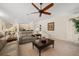 Spacious living room featuring a ceiling fan, neutral colors, and plenty of natural light at 11137 Woodland Waters Blvd, Weeki Wachee, FL 34613