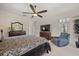 Another view of main bedroom featuring plush carpet, ceiling fan, and large flat screen television at 11137 Woodland Waters Blvd, Weeki Wachee, FL 34613