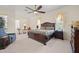 Main bedroom boasts a ceiling fan, decorative furnishings, and natural light at 11137 Woodland Waters Blvd, Weeki Wachee, FL 34613