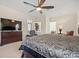 Spacious main bedroom featuring plush carpeting and a large flat screen television at 11137 Woodland Waters Blvd, Weeki Wachee, FL 34613
