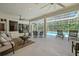 Large, covered patio with ample seating around a beautiful in-ground pool at 11137 Woodland Waters Blvd, Weeki Wachee, FL 34613
