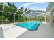 Screened-in pool with sunny patio, offering a private retreat for relaxation and recreation at 11137 Woodland Waters Blvd, Weeki Wachee, FL 34613