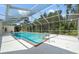 Inviting in-ground pool with a screened enclosure, offering privacy and enjoyment at 11137 Woodland Waters Blvd, Weeki Wachee, FL 34613