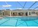 Lovely pool with crystal blue water, bordered by a patio and a screened-in lanai area at 11137 Woodland Waters Blvd, Weeki Wachee, FL 34613