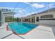 Beautiful in-ground pool surrounded by a screened lanai and ample patio space at 11137 Woodland Waters Blvd, Weeki Wachee, FL 34613
