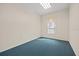 Carpeted room with neutral walls and a window with sheer curtains at 11137 Woodland Waters Blvd, Weeki Wachee, FL 34613