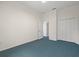 Carpeted room with white walls, white trim, and a double door closet at 11137 Woodland Waters Blvd, Weeki Wachee, FL 34613