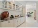 Chic wet bar area with marble countertops, display cabinets, and convenient access to dining areas at 11137 Woodland Waters Blvd, Weeki Wachee, FL 34613