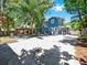 Charming two-story home featuring a spacious backyard with a cozy pergola and outdoor seating area at 112 W Mohawk Ave, Tampa, FL 33604