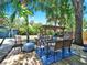 Backyard featuring a dining set, pergola, and tropical landscaping at 112 W Mohawk Ave, Tampa, FL 33604