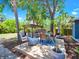 Backyard with pergola, dining set, and lush tropical landscaping at 112 W Mohawk Ave, Tampa, FL 33604