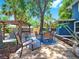 Backyard with a dining set, pergola, and charming landscaping at 112 W Mohawk Ave, Tampa, FL 33604