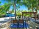 Spacious backyard featuring a deck, dining area, pergola, and garage at 112 W Mohawk Ave, Tampa, FL 33604