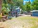 Charming two-story home featuring a spacious backyard with a cozy pergola and outdoor seating area at 112 W Mohawk Ave, Tampa, FL 33604