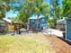 Charming two-story home featuring a spacious backyard with a cozy pergola and outdoor seating area at 112 W Mohawk Ave, Tampa, FL 33604