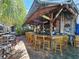 Funky outdoor bar with wooden stools, covered roof, and unique decorations at 112 W Mohawk Ave, Tampa, FL 33604