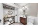 A well-organized bathroom featuring ample shelving and storage, complete with a classic vanity and round mirror at 112 W Mohawk Ave, Tampa, FL 33604