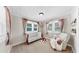 Cozy Bedroom featuring a crib, comfortable chair, and soft natural light at 112 W Mohawk Ave, Tampa, FL 33604