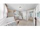 Cozy Bedroom featuring a crib, comfortable chair, and soft natural light at 112 W Mohawk Ave, Tampa, FL 33604