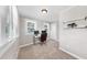 Neutral bedroom featuring a desk with computer, lots of natural light, and carpeted floors at 112 W Mohawk Ave, Tampa, FL 33604