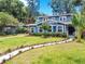 Charming two-story home with lush landscaping and a well-manicured lawn at 112 W Mohawk Ave, Tampa, FL 33604