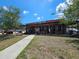 Rustic Seminole Heights restaurant exterior with barrels, stools, and a long porch at 112 W Mohawk Ave, Tampa, FL 33604