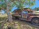 The side of a rustic sandwich restaurant, with old farm truck and sandwich sign at 112 W Mohawk Ave, Tampa, FL 33604