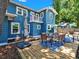Back exterior view featuring balcony and dining area on wooden deck at 112 W Mohawk Ave, Tampa, FL 33604