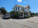Multi-story white building with wrap-around porch and street parking available at 112 W Mohawk Ave, Tampa, FL 33604
