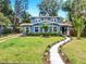 Charming two-story home with lush landscaping and a well-manicured lawn at 112 W Mohawk Ave, Tampa, FL 33604