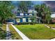 Charming two-story home with a lush green lawn and beautiful landscaping at 112 W Mohawk Ave, Tampa, FL 33604
