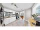 The kitchen showcases stainless steel appliances, a breakfast bar, tiled floors and backsplash and modern lighting at 112 W Mohawk Ave, Tampa, FL 33604