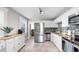 Bright kitchen features stainless steel appliances, granite countertops, and modern tiling at 112 W Mohawk Ave, Tampa, FL 33604