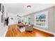 Bright living room featuring hardwood floors, large windows, and comfortable seating at 112 W Mohawk Ave, Tampa, FL 33604