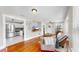 Open-concept living room with hardwood floors flowing into an adjacent kitchen at 112 W Mohawk Ave, Tampa, FL 33604