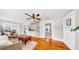 A view of the living room showing wood floors, a ceiling fan, and a stairway leading to the second floor at 112 W Mohawk Ave, Tampa, FL 33604