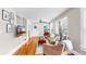 Bright living room with hardwood floors, a comfortable sofa, a television and natural light from the windows at 112 W Mohawk Ave, Tampa, FL 33604