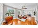 Inviting living room featuring beautiful wood floors and ample natural light at 112 W Mohawk Ave, Tampa, FL 33604