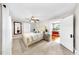 The main bedroom is bright with an ensuite bathroom and natural light; ceiling fan and carpet flooring at 112 W Mohawk Ave, Tampa, FL 33604