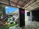 Relaxing, covered outdoor patio seating with unique artificial grass and neon sign at 112 W Mohawk Ave, Tampa, FL 33604