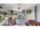 Charming front porch featuring comfortable seating and decorative floral accents at 112 W Mohawk Ave, Tampa, FL 33604