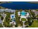 Stunning aerial view of the community's pool, splashpad, and amenities surrounded by lush landscaping and the calm lake at 11550 Lake Lucaya Dr, Riverview, FL 33579