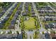 A beautiful aerial view of a suburban community with a central green space and playground at 11550 Lake Lucaya Dr, Riverview, FL 33579