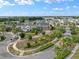 Picturesque aerial view showcasing a neighborhood with lush landscaping, brick driveways, and a tranquil lake at 11550 Lake Lucaya Dr, Riverview, FL 33579