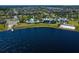 Breathtaking aerial view of the community featuring a lake, with a beach, pool, and lakeside amenities amidst lush greenery at 11550 Lake Lucaya Dr, Riverview, FL 33579