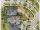 Aerial view of homes showcasing private pools, brick driveways, mature landscaping, and cul-de-sac street at 11550 Lake Lucaya Dr, Riverview, FL 33579