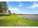 Expansive backyard featuring lush green lawn and tranquil lake views, a great place to relax and enjoy the outdoors at 11550 Lake Lucaya Dr, Riverview, FL 33579