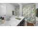 Bright bathroom with a double sink vanity, decorative shower curtain, and updated fixtures, perfect for a clean and modern look at 11550 Lake Lucaya Dr, Riverview, FL 33579